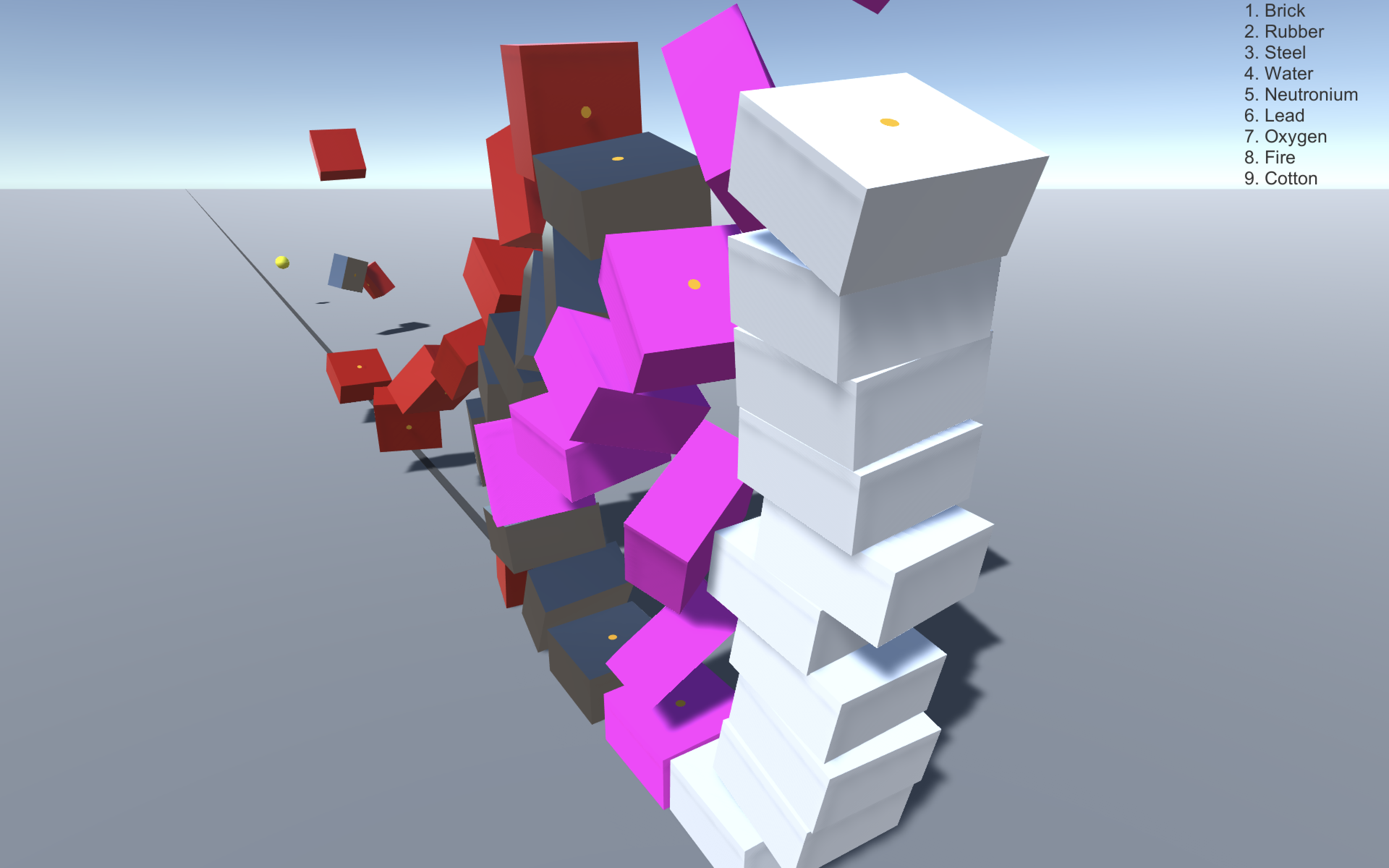 4 seperate towers of red gray pink and white boxes are consecutively knocked over by small yellow ball
