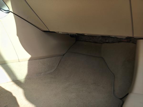 The passenger footwell of a car, with very little indication that a mood lighting system has been installed
