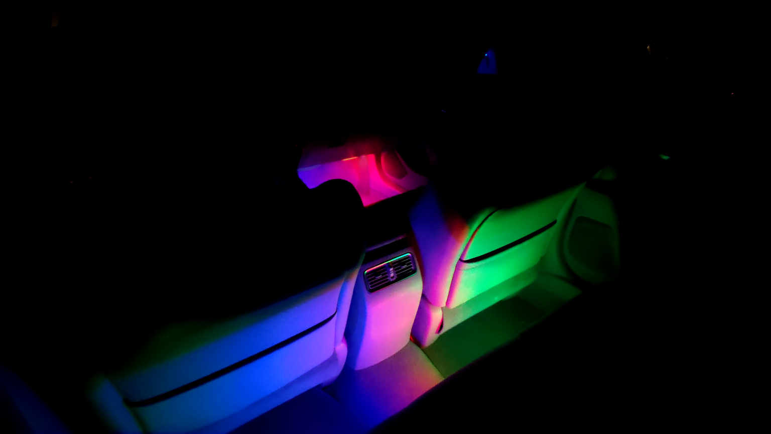 Mood lighting filling the interior of a car with a gradient of several colors