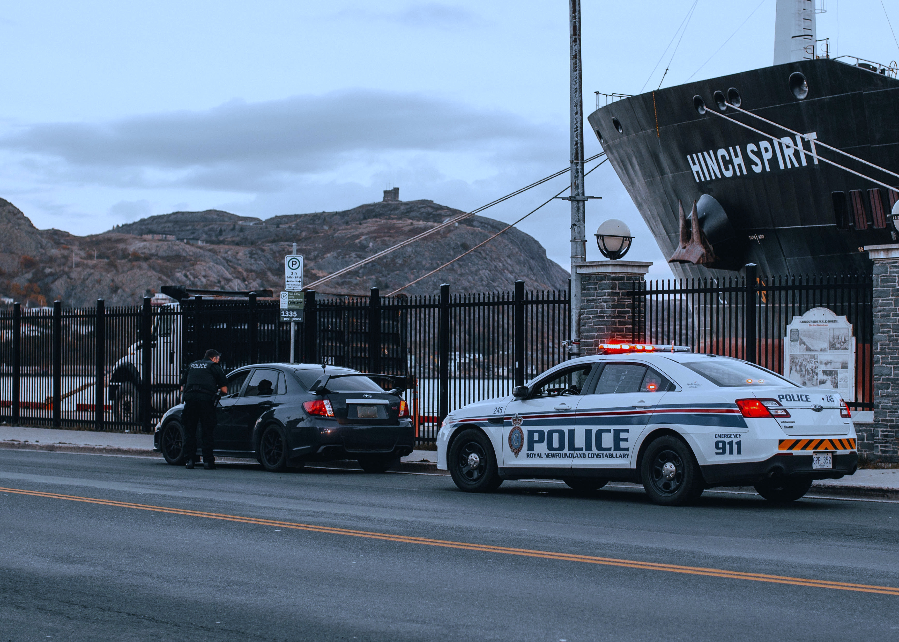 An image of a driver pulled over by a police officer on the side of a road